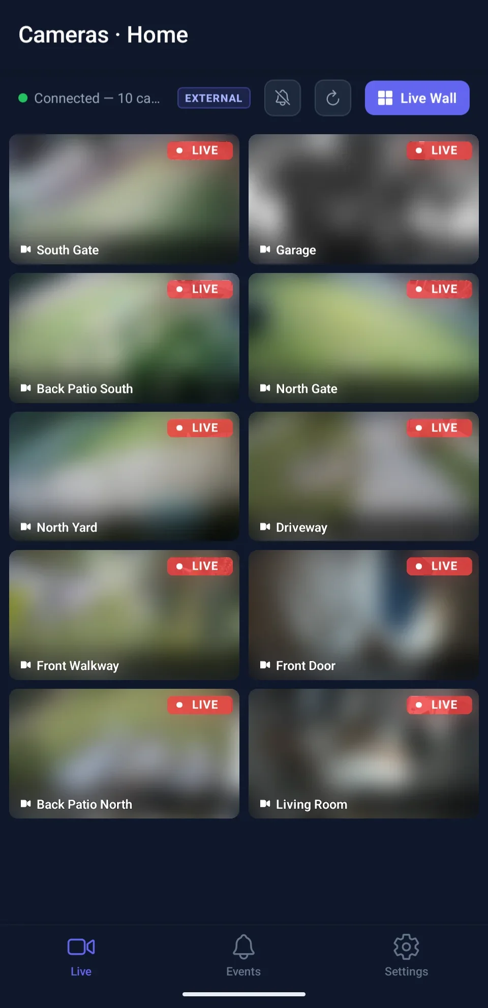 Cameras tab showing a two-column grid of ten live camera tiles, feeds blurred